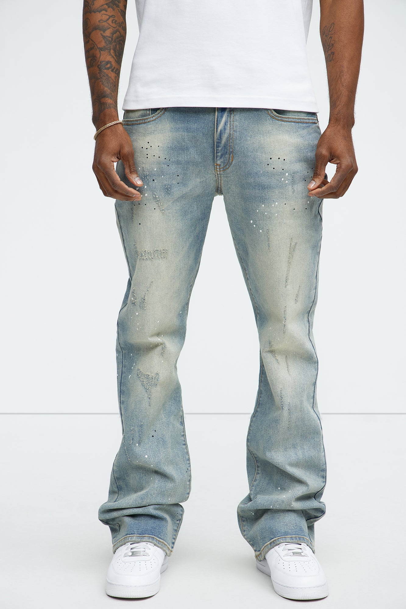 Ripped And Bleach Splatter Stacked Slim Flare Jeans deslavado claro azul